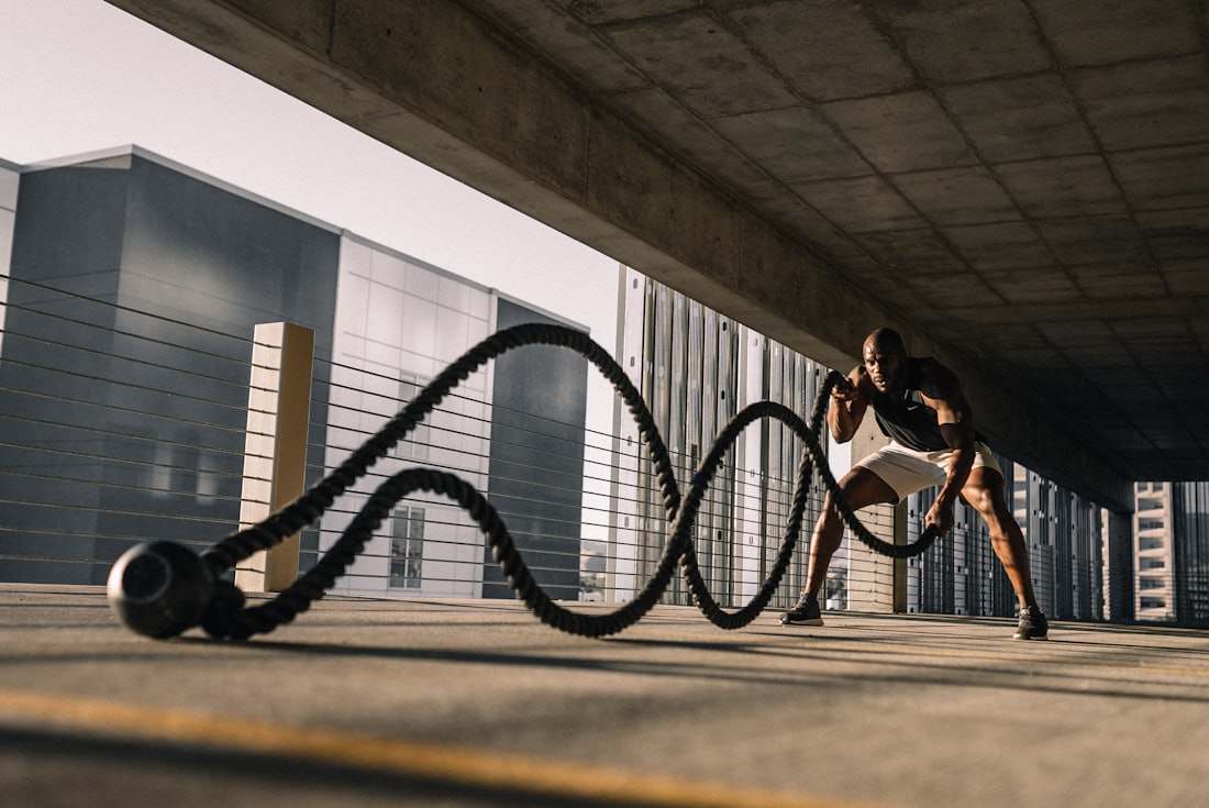 Athlete driving battle ropes outdoors